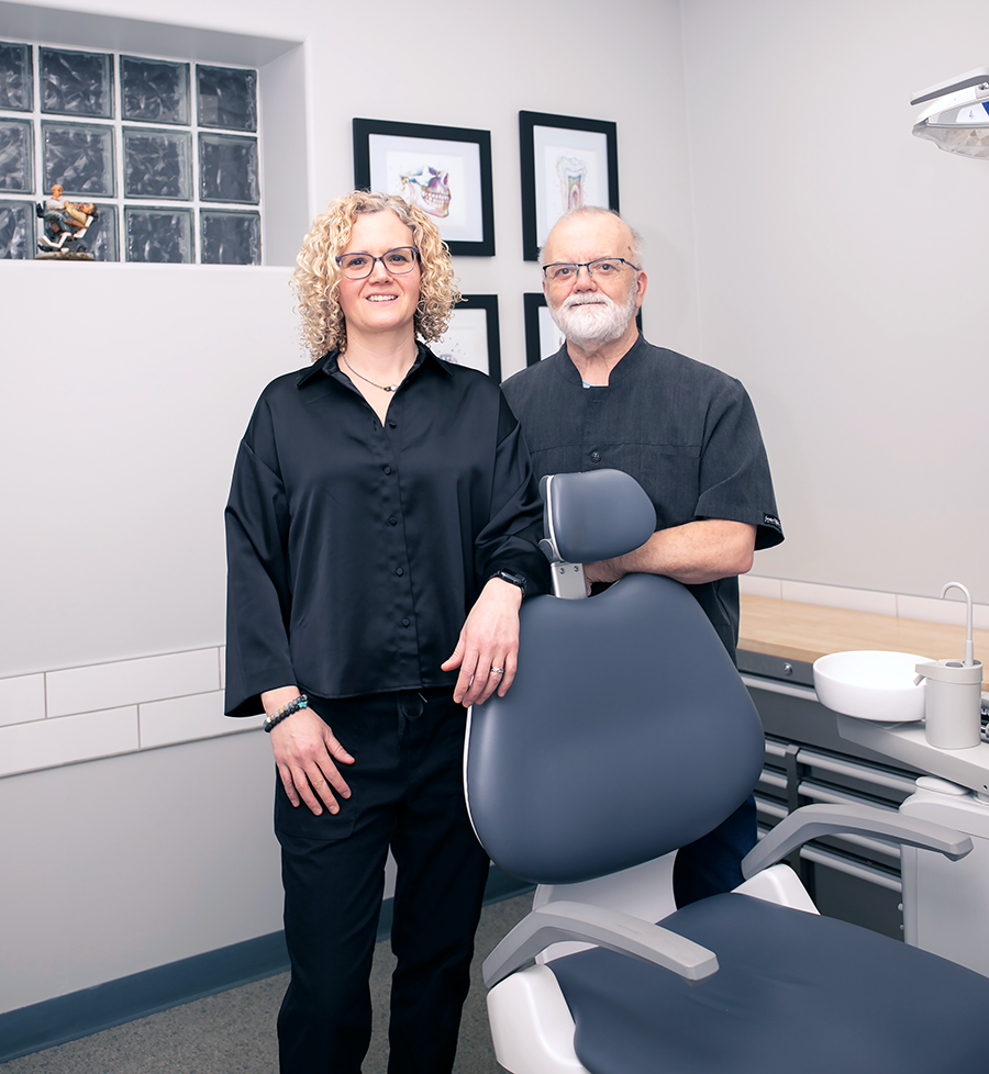 Melanie Lacroix and Serge Lacroix standing beside a dentist chair.